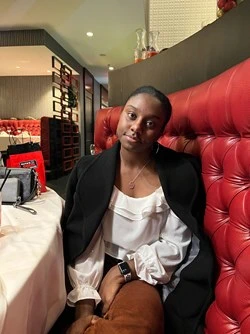 photo of young woman sitting in a restaurant booth